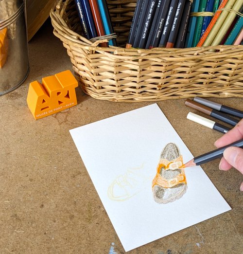 L'artiste en pleine création d'une illustration aux crayons de couleurs dans son atelier